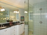 Master bathroom has double sinks and a walk in shower